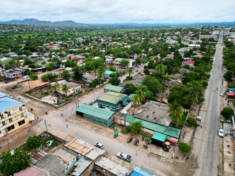 A vibrant aerial view of a city in Africa with lush greenery and urban structures.
