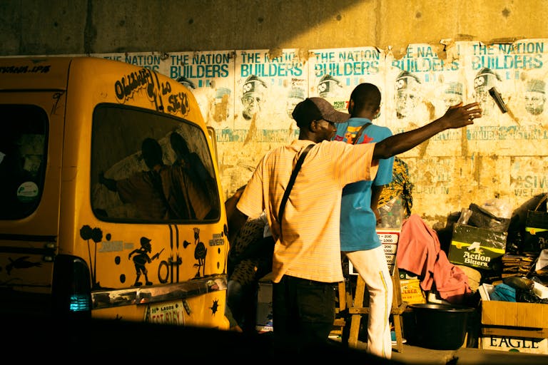 Vibrant Lagos street scene at golden hour with people and danfo bus.